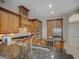 Gourmet kitchen with dark countertops, stainless steel appliances, and custom wood cabinetry at 4335 Clairidge Way, Palm Harbor, FL 34685