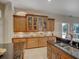 Well-appointed kitchen featuring dark countertops, ample cabinetry, and an adjacent outdoor view at 4335 Clairidge Way, Palm Harbor, FL 34685