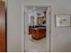View of the kitchen featuring dark countertops and a large island, framed by a doorway at 4335 Clairidge Way, Palm Harbor, FL 34685