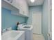 Laundry room featuring a washer, dryer, utility sink and storage cabinets at 4335 Clairidge Way, Palm Harbor, FL 34685