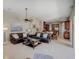 Spacious living room open to the kitchen featuring tile floors and comfortable leather sofas at 4335 Clairidge Way, Palm Harbor, FL 34685