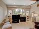 Living room showcases a fireplace, built-in shelving, and a large arched window with natural light at 4335 Clairidge Way, Palm Harbor, FL 34685