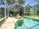 Beautiful screened pool and spa area surrounded by lush landscaping for privacy at 4335 Clairidge Way, Palm Harbor, FL 34685