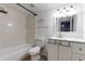 Bathroom boasts a tile shower and tub, white vanity, and updated fixtures at 4411 Shady Terrace Ln # 213, Tampa, FL 33613