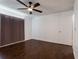 Bedroom featuring hardwood floors, a ceiling fan and window with brown curtains at 4411 Shady Terrace Ln # 213, Tampa, FL 33613