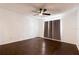 Spacious bedroom features hardwood floors, a ceiling fan and window with brown curtains at 4411 Shady Terrace Ln # 213, Tampa, FL 33613