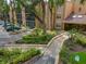 Condo building has a sidewalk leading to a large entrance with landscaping and parking spaces at 4411 Shady Terrace Ln # 213, Tampa, FL 33613