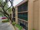 Exterior view of a building showing screened-in patios with a partial parking lot view at 4411 Shady Terrace Ln # 213, Tampa, FL 33613