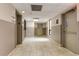Brightly lit hallway with elevators and access to an emergency exit at 4411 Shady Terrace Ln # 213, Tampa, FL 33613