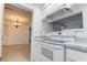 Open kitchen view showcasing white cabinets, countertops, and appliances, seamlessly blending style with functionality at 4411 Shady Terrace Ln # 213, Tampa, FL 33613