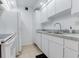 Cozy kitchen featuring white cabinetry, appliances, and light countertops for a clean and inviting space at 4411 Shady Terrace Ln # 213, Tampa, FL 33613