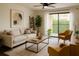 Bright living room featuring a ceiling fan, comfortable seating, and sliding door to a balcony at 4411 Shady Terrace Ln # 213, Tampa, FL 33613