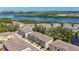 Scenic aerial view of modern townhomes in a waterfront community offering serene water views and lush trees at 4567 Tuscan Loon Dr, Tampa, FL 33619