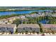 An aerial view capturing the community near the water, featuring townhouse exteriors and tranquil scenery at 4567 Tuscan Loon Dr, Tampa, FL 33619