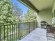 Enjoy the tiled balcony featuring rod iron railing, a grill, and outdoor seating area overlooking the lush views at 4567 Tuscan Loon Dr, Tampa, FL 33619