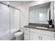 Bathroom featuring vanity, toilet, and shower with glass doors and white subway tile surround at 4567 Tuscan Loon Dr, Tampa, FL 33619