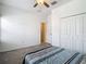 This bedroom features neutral walls, carpet flooring, a ceiling fan and a double closet for storage at 4567 Tuscan Loon Dr, Tampa, FL 33619
