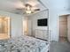 This is a bedroom with neutral walls, carpet flooring, a ceiling fan and a view to the bathroom and closet at 4567 Tuscan Loon Dr, Tampa, FL 33619