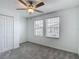 Comfortable bedroom with neutral carpet, fan, and two windows providing natural light at 4567 Tuscan Loon Dr, Tampa, FL 33619