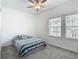 Bedroom featuring carpet floors, a ceiling fan, and large windows at 4567 Tuscan Loon Dr, Tampa, FL 33619