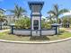 Well-maintained community entrance featuring manicured plants and an elegant Palm River sign at 4567 Tuscan Loon Dr, Tampa, FL 33619