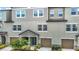 Attractive townhome exterior showcasing a two-car garage and well-maintained landscaping at 4567 Tuscan Loon Dr, Tampa, FL 33619