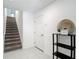 Bright foyer featuring tile floors, staircase, a convenient coat closet, and decorative accents at 4567 Tuscan Loon Dr, Tampa, FL 33619