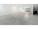 Large empty garage featuring white walls, sealed concrete floor, and room for storage and multiple vehicles at 4567 Tuscan Loon Dr, Tampa, FL 33619