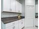 Close up on white cabinets, granite counters, and stainless hardware in the kitchen at 4567 Tuscan Loon Dr, Tampa, FL 33619