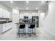 Spacious kitchen with island, white cabinets, stainless appliances, and eat in breakfast bar at 4567 Tuscan Loon Dr, Tampa, FL 33619