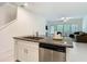 Kitchen island with granite counters, stainless dishwasher, and open view to the living room at 4567 Tuscan Loon Dr, Tampa, FL 33619
