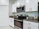 Modern kitchen features stainless steel appliances, ample counter space, and clean white cabinetry at 4567 Tuscan Loon Dr, Tampa, FL 33619