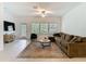 Bright living room with large windows, a cozy couch, and neutral decor create a welcoming atmosphere at 4567 Tuscan Loon Dr, Tampa, FL 33619