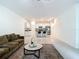 An open-concept living room and kitchen layout boasts bright lighting and ample seating options at 4567 Tuscan Loon Dr, Tampa, FL 33619