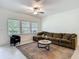 An open living room with a comfortable couch, area rug, and neutral colors creates a relaxing space at 4567 Tuscan Loon Dr, Tampa, FL 33619
