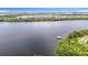 Expansive waterfront view featuring a private dock and lush green shoreline for relaxing outdoor enjoyment at 4567 Tuscan Loon Dr, Tampa, FL 33619