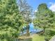 The community boasts a serene water view framed by green trees and a reflection of blue skies at 4567 Tuscan Loon Dr, Tampa, FL 33619