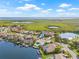 Stunning aerial view of waterfront homes with private docks, pools, and lush landscaping in a coastal community at 5002 E Longboat Blvd, Tampa, FL 33615