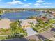 Aerial view of a home with a large lake in the background, palm trees, and well-maintained landscaping at 5002 E Longboat Blvd, Tampa, FL 33615