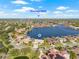 Aerial view showcasing a waterfront home on a canal with beautiful landscaping and a view of Downtown Tampa at 5002 E Longboat Blvd, Tampa, FL 33615