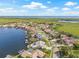 Aerial view of waterfront home, surrounded by manicured lawns, lush landscapes, with a clear blue pool and spa at 5002 E Longboat Blvd, Tampa, FL 33615