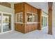 A wooden bar with glass windows opens to the home's kitchen at 5002 E Longboat Blvd, Tampa, FL 33615