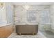 A luxury bathroom boasts a freestanding soaking tub and glass shower, highlighted by marble accents at 5002 E Longboat Blvd, Tampa, FL 33615