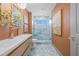 Modern bathroom featuring blue accent wall and floor, stylish vanity, and glass shower at 5002 E Longboat Blvd, Tampa, FL 33615