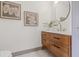 Stylish powder room with modern vanity, decorative mirror, and contemporary lighting at 5002 E Longboat Blvd, Tampa, FL 33615