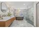 Stunning bathroom features dual sinks, soaking tub, and glass enclosed shower with beautiful marble tile at 5002 E Longboat Blvd, Tampa, FL 33615