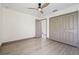 This bedroom features wood-look floors, a ceiling fan, a closet, and base molding at 5002 E Longboat Blvd, Tampa, FL 33615