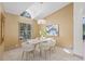 Light and airy dining room featuring modern chandelier and ample natural light at 5002 E Longboat Blvd, Tampa, FL 33615