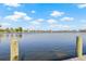 View from wooden dock of calm canal with a community of waterfront homes on opposite shore, offering boating and water activities at 5002 E Longboat Blvd, Tampa, FL 33615