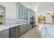 Modern kitchen with light blue cabinets, marble backsplash, stainless steel appliances and eat in kitchen at 5002 E Longboat Blvd, Tampa, FL 33615